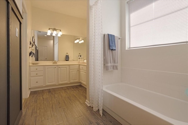 bathroom with vanity, hardwood / wood-style flooring, and shower / bath combo