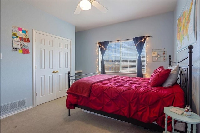 bedroom with ceiling fan, carpet floors, and a closet