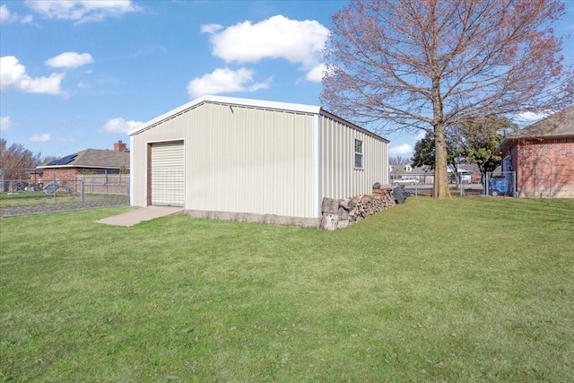 exterior space with an outbuilding, a garage, and a lawn