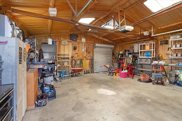 garage with a garage door opener and a workshop area