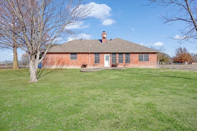 back of property with a patio and a lawn