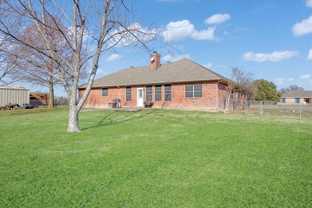 back of property with a lawn