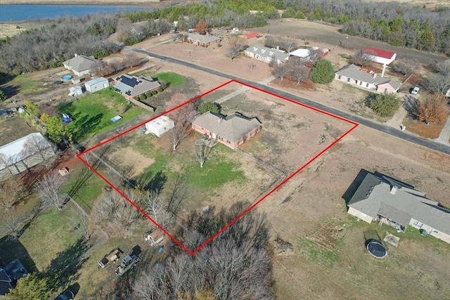 birds eye view of property with a water view