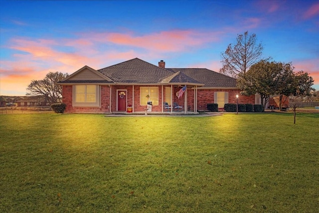 ranch-style home with a yard