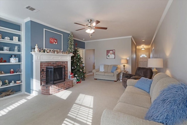 living room featuring built in features, ceiling fan, carpet, ornamental molding, and a brick fireplace