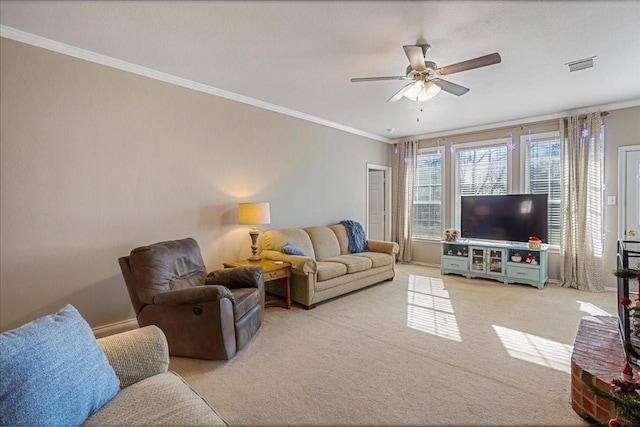 carpeted living room with ornamental molding and ceiling fan