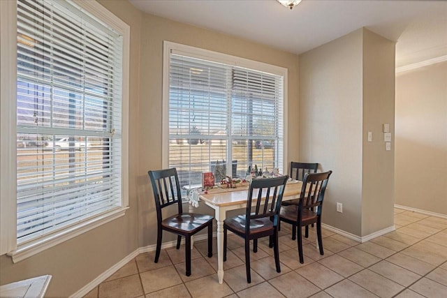 dining area with light tile patterned floors