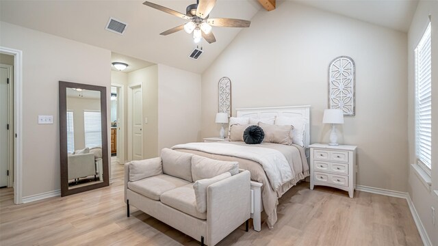 bedroom featuring multiple windows, lofted ceiling with beams, light hardwood / wood-style floors, and ceiling fan