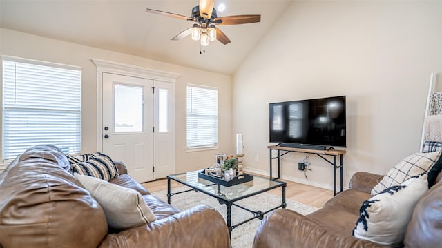 living room with light wood-type flooring, high vaulted ceiling, and ceiling fan