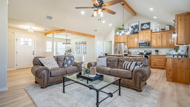 living room with beamed ceiling, ceiling fan with notable chandelier, high vaulted ceiling, and light hardwood / wood-style flooring