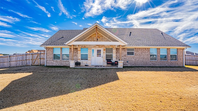 rear view of property with a yard and a patio