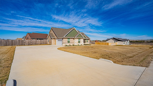 view of front of home featuring a garage and a front yard