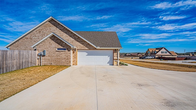 view of front of property with a garage and a front lawn