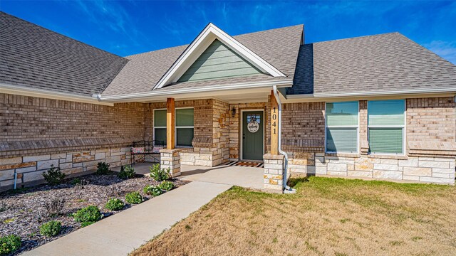 view of front of home with a porch and a front yard