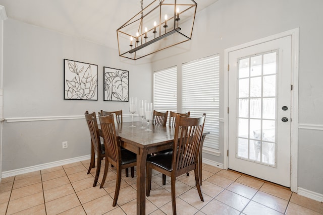 dining area with a chandelier, light tile patterned floors, and a wealth of natural light