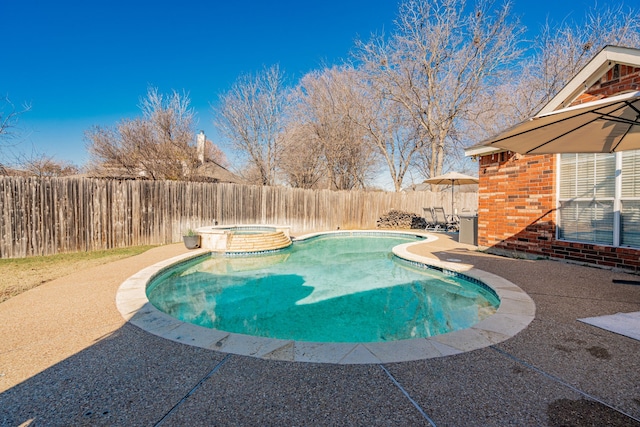 view of swimming pool featuring an in ground hot tub and a patio