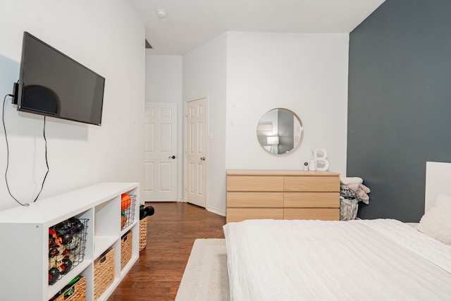 bedroom with dark hardwood / wood-style flooring