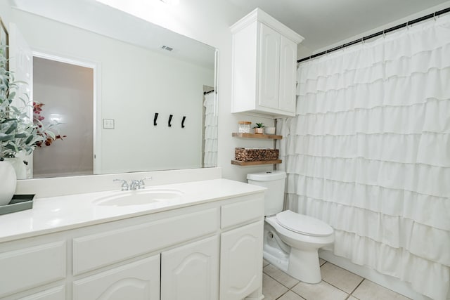 full bathroom with tile patterned flooring, vanity, toilet, and shower / bath combo with shower curtain