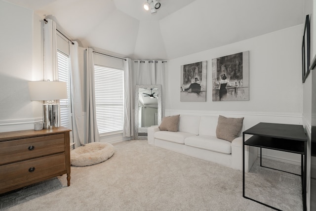 carpeted living room with ceiling fan, a healthy amount of sunlight, and lofted ceiling