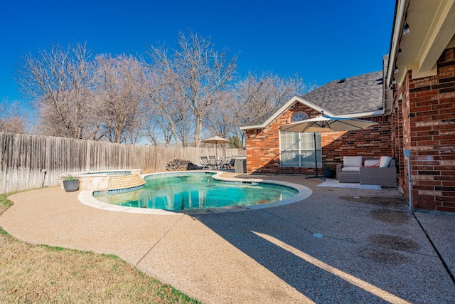 view of pool with a patio area and an in ground hot tub