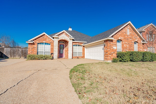 view of front facade featuring a front yard and a garage