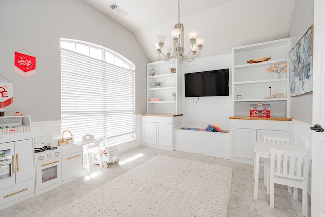 playroom with light colored carpet, lofted ceiling, and a notable chandelier