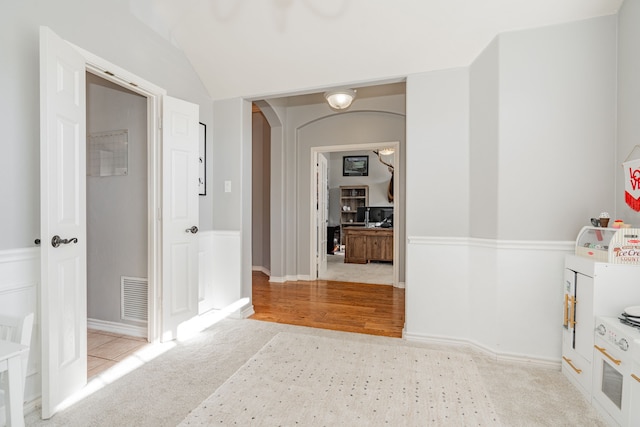 hallway featuring light colored carpet