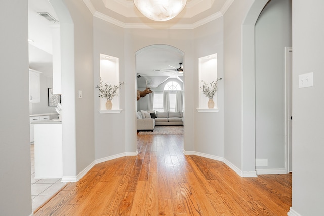 hall featuring ornamental molding and light hardwood / wood-style flooring