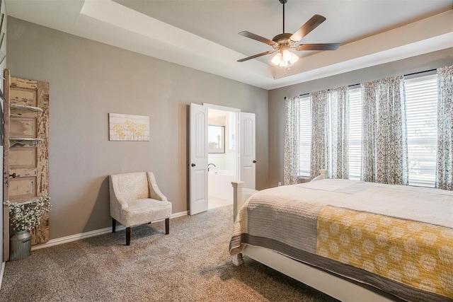 bedroom with carpet, a tray ceiling, ceiling fan, and ensuite bathroom