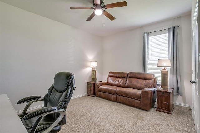 carpeted office space featuring ceiling fan