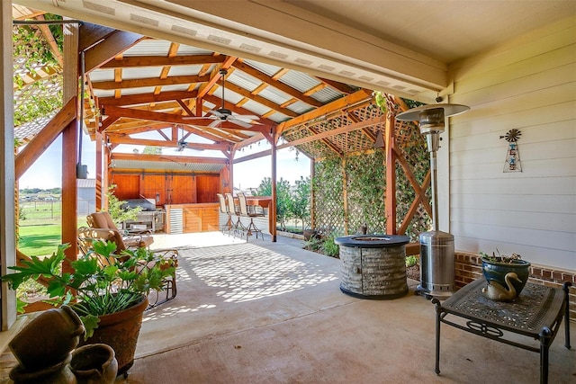 view of patio / terrace featuring a gazebo, ceiling fan, and a bar