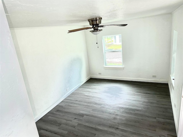 empty room featuring dark wood-style flooring, ceiling fan, and baseboards