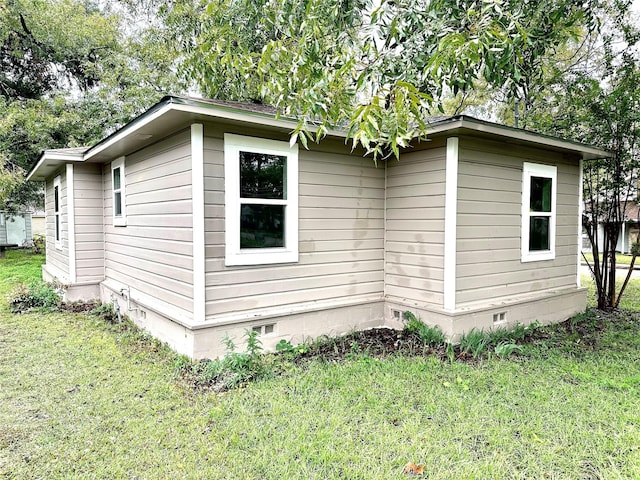 view of property exterior with crawl space and a lawn