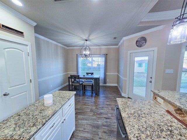 kitchen featuring a notable chandelier, decorative light fixtures, light stone countertops, and white cabinetry