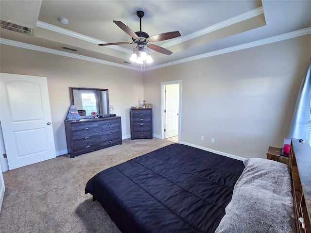 carpeted bedroom featuring a raised ceiling, ceiling fan, and ornamental molding