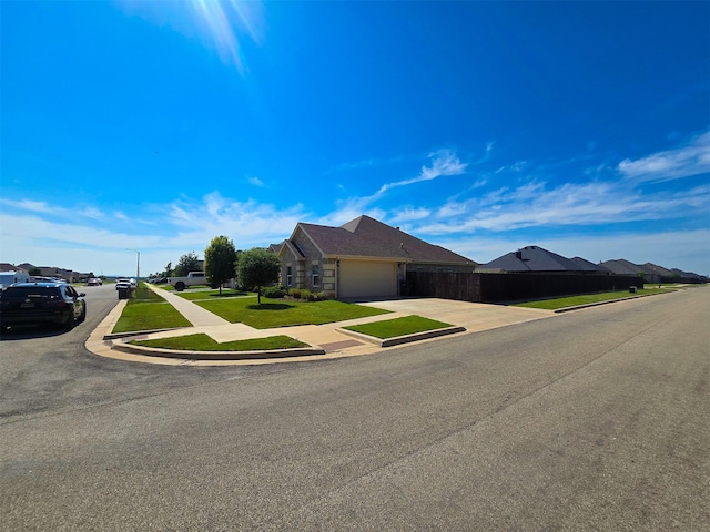 ranch-style house with a garage and a front lawn