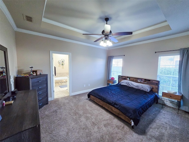 carpeted bedroom with ceiling fan, ornamental molding, and a tray ceiling