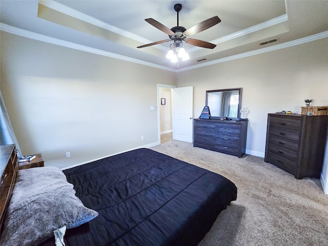 carpeted bedroom with a raised ceiling, ceiling fan, and crown molding