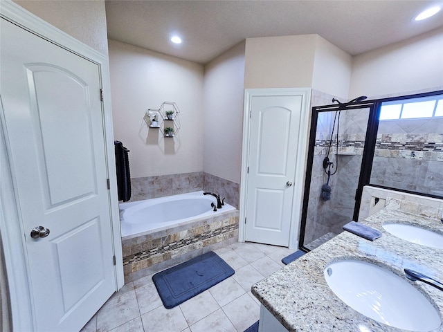 bathroom featuring tile patterned floors, vanity, and shower with separate bathtub