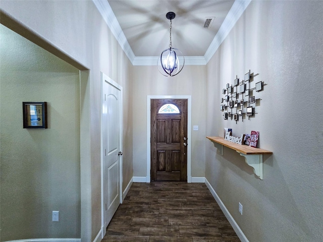 foyer entrance featuring crown molding, dark hardwood / wood-style flooring, and a chandelier