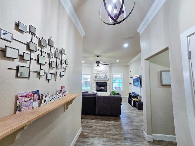 hallway featuring dark hardwood / wood-style floors, ornamental molding, and a notable chandelier