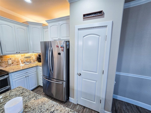 kitchen with backsplash, light stone counters, white cabinetry, and stainless steel appliances