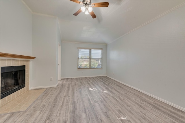 unfurnished living room featuring ceiling fan, light wood-type flooring, a fireplace, and ornamental molding