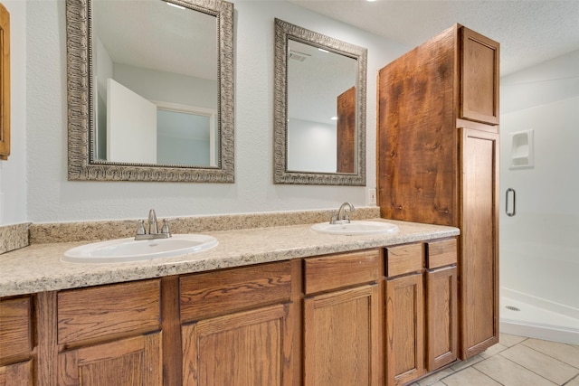 bathroom featuring a shower, tile patterned flooring, and vanity