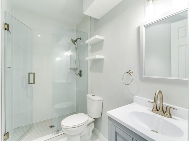 bathroom featuring vanity, toilet, and walk in shower