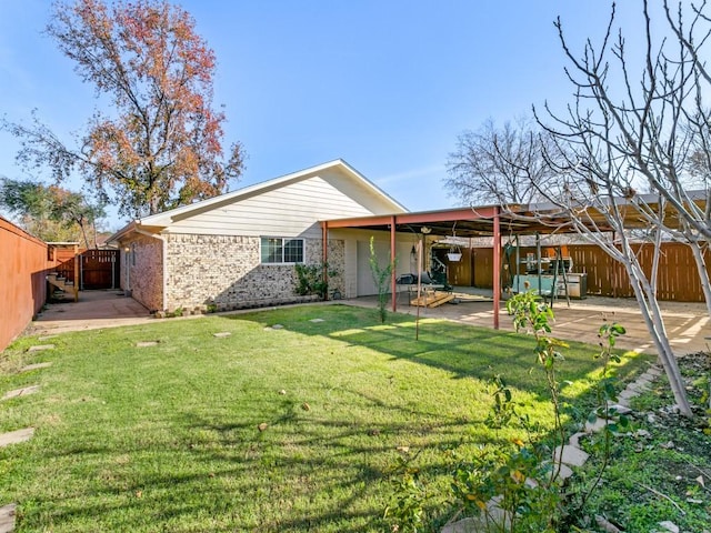 back of property featuring a yard and a patio area