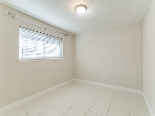 unfurnished room with light tile patterned floors