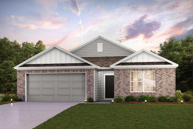 view of front of home with a garage and a lawn