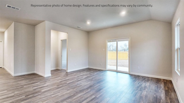 unfurnished room with hardwood / wood-style flooring and vaulted ceiling