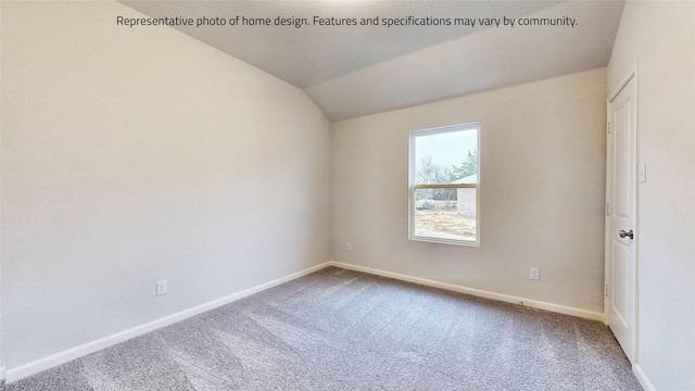 carpeted spare room with vaulted ceiling